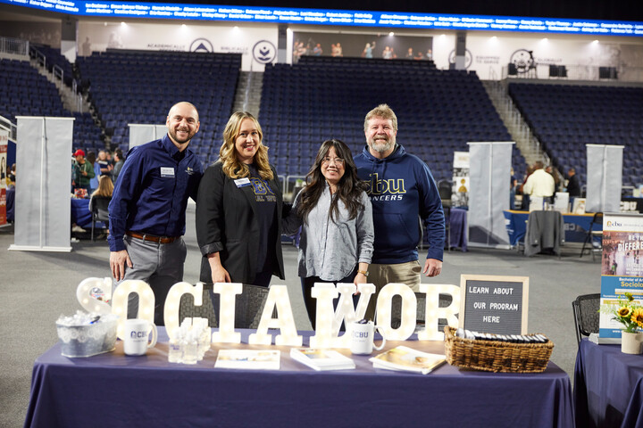 professors behind booth that says social work