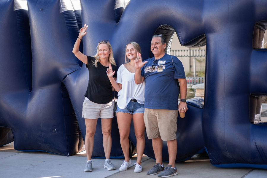 cbu student posing with parents