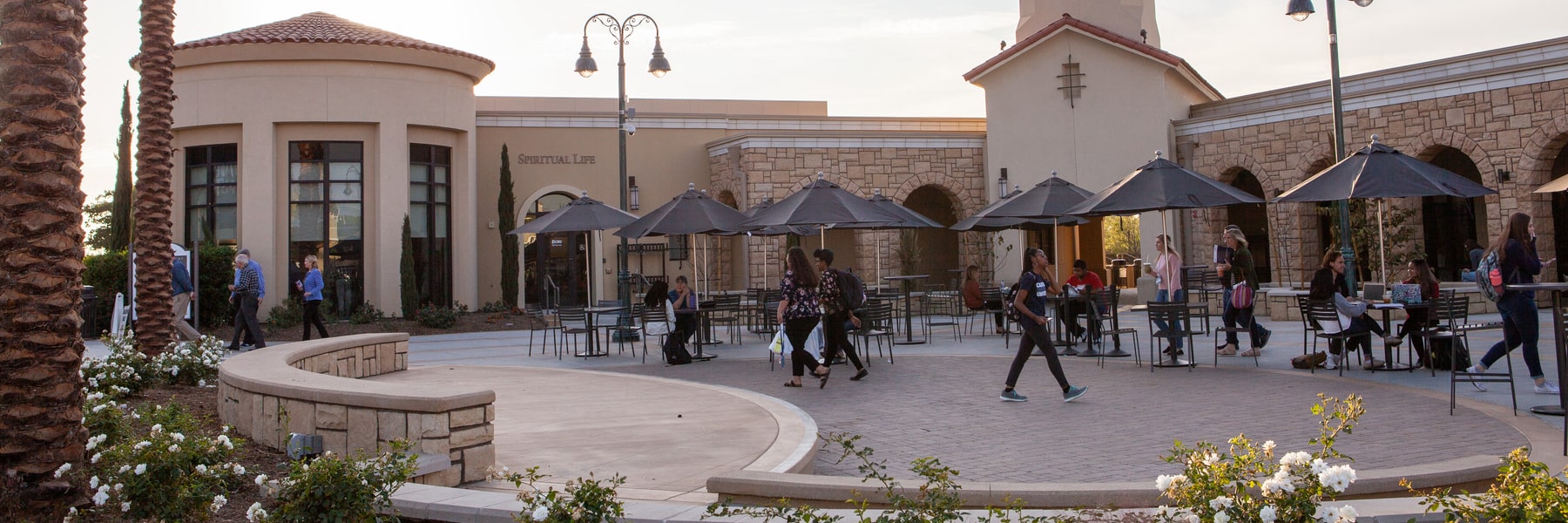 CBU students walking through and sitting in Lancer Plaza on campus