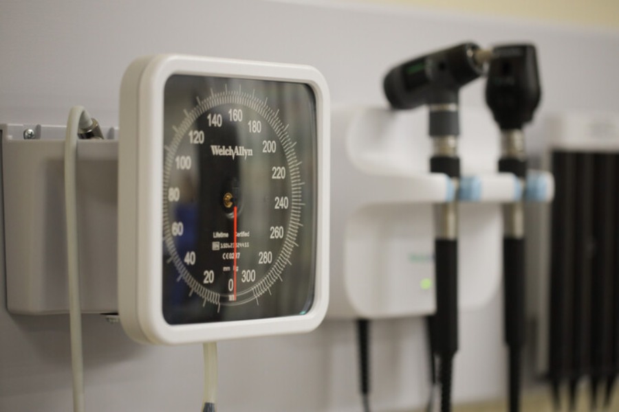 A blood pressure monitor and other medical equipment hanging on the wall
