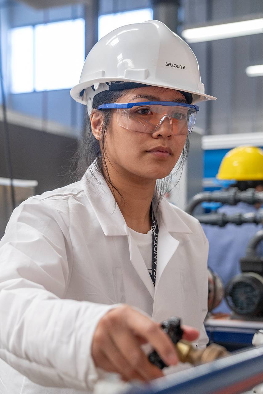 A CBU chemical engineering student working in a lab